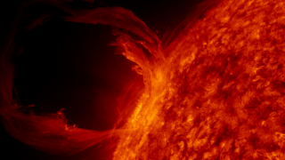 Solar prominence — bright plasma loop extending from the solar limb (NASA/SDO AIA 304)
