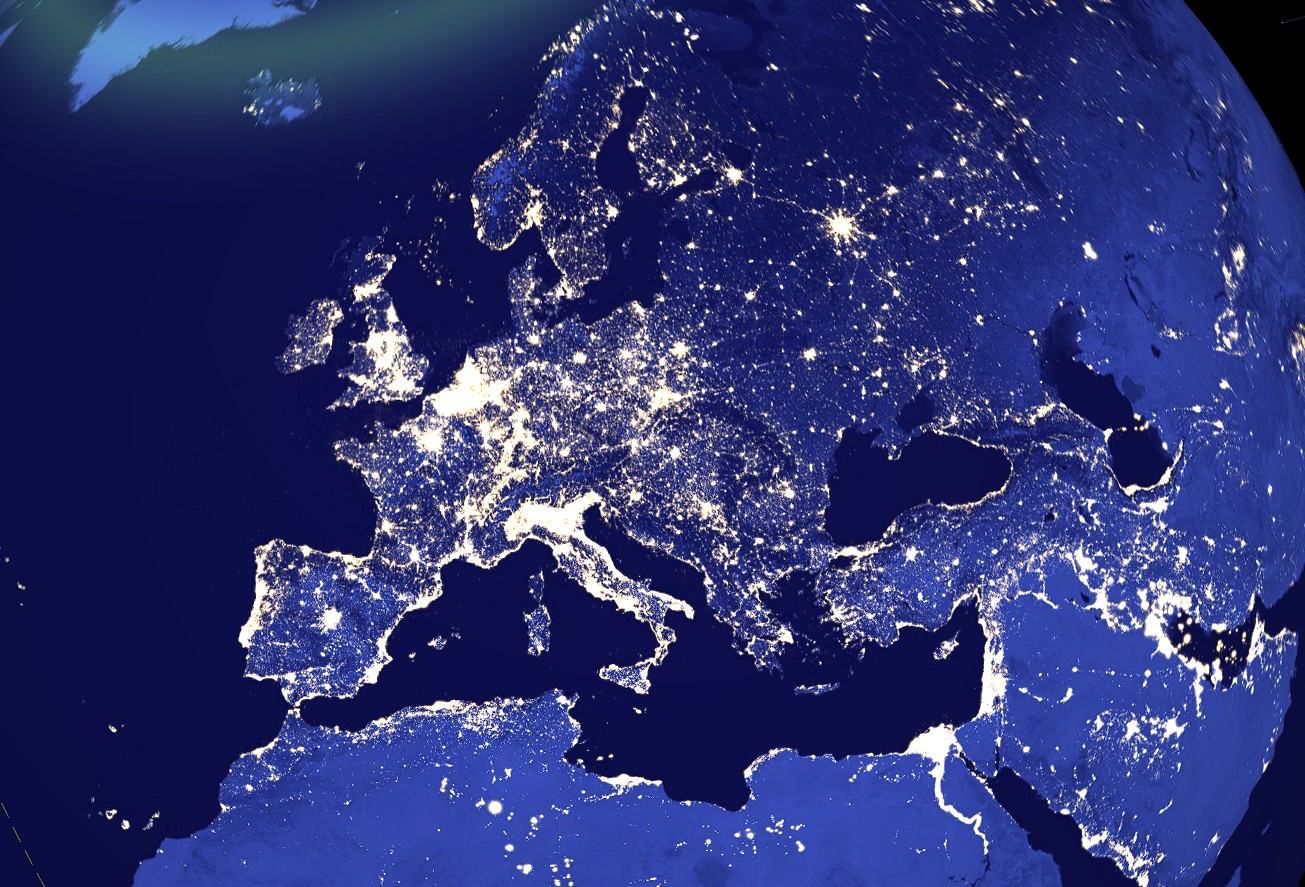 Night-side view of Earth over Europe, showing city lights as a web of glowing dots across the continent